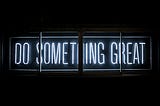 a neon sign that says “do something great”