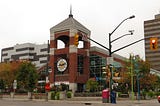 The tower that is the main entrance to Convent Garden Market in London, Ontario. A streetlight can be seen in the foreground, with the market’s entrance behind it. A road closed sign can be seen as well, because London.