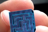 AR cube with a maze indented into it, held by hand