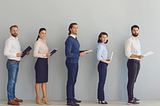 An image at brianvanderwaal.com/personal-profile-for-cv of 5 job applicants with CVs in hands lining up waiting to be interviewed. A strong CV with an effective Personal Profile can help to ensure you are shortlisted.