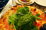 Pizza at Lil’ Frankie’s. Thick, sourdough base, topped with prosciutto and rocket.