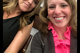 Photo of two women, one wearing a black dress and one wearing a hot pink shirt and brown jacket. Kathryn Harvey, Spartanburg DPC and Amanda McDougald Scott, GCDP watching the SC House Judiciary Committee on the morning of May 9.