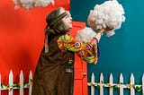 Older woman dressed in hippie clothes playing with a fake cloud in a garden. Peace. Older. Healthy.