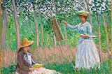 A painting by Claude Monet from 1887: “In the Woods at Giverny, Blanche Hoschedé Monet at Her Easel with Suzanne Hoschedé”. Trees in a very green background, in the foreground, a woman dressed in white is standing at her easel on the right, at the bottom left a woman wearing darker colors is sitting on the grass, reading. Both women are wearing straw hats.