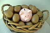 Eggs and a piggy bank in a basket.