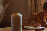 image of a woman writing in a notebook