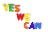 Colorful magnet letters spelling out YES WE CAN.