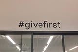 The #givefirst sticker on our co-working wall during the 2019 Techstars & Western Union Accelerator.
