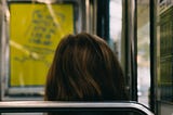 The back of the head of a brunette woman sitting on a bus. Photo by Mathias Reding: https://www.pexels.com/photo/back-of-the-head-of-a-woman-sitting-in-a-bus-9845230/