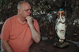 An unhappy man considers a happy clown