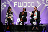 Panelists appear on bar stools from last year’s conference with a blue backdrop which reads FWD50 in big, bold white letters.