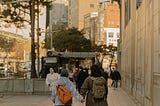 People walking on a sidewalk in a city