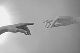 Image showing a human hand and an AI hand