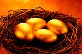 Four golden eggs in a nest