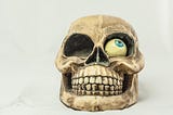 Comical smiling skull with one eye out