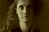 An albumen print from 1867, featuring a model gazing into the camera, almost expressionless.