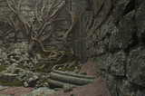 A detailed rock wall next to some rocks on the ground, and another rock wall with tree bits on it in Lords of the Fallen.