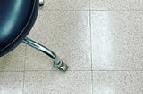 picture of a rolling stool in a hospital exam room.