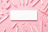 Blank white box in the middle of a pink background. Lots of pencils surround it.