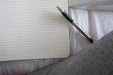 A pen and piece of blank lined paper.