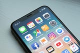 iPhone X on a blue-grey background