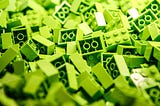 A pile of lime green lego blocks.