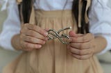 Little girl holding a metal knot.