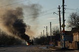 A bus burns in the early days of Russia’s invasion of Ukraine