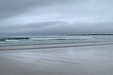grey empty beach and grey sky.