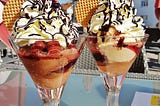 Ice cream with cherries and whipped cream in sundae glasses