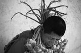 Man looking down with garlic strand around his neck