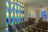 Behind the altar in the nave of the Matisse Chapel are the artist’s “Tree of Life” windows. (Claude Almodovar/© 2019 Succession H. Matisse/Artists Rights Society (ARS), New York)
