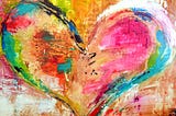 A heart painted in a variety of bold colors.