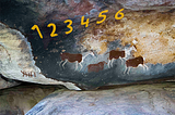 Stone Age rock art showsanimals and an overlay of numbers and tally marks.