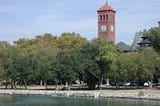 Clock tower and green trees on the waterfront