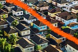 An ariel view of houses bisected by a painted red brush stroke.