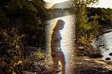 Illusion of female figure in overlay of a lake scenery.