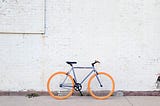 bicycle leaning against a wall