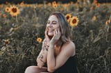 Lady in Sunflower field smiling and happy