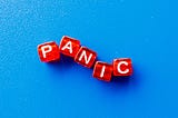 The word panic spelled out in red blocks on a blue background.