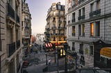A Parisian street with building buildings and a Métro entrance.