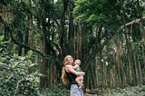 A picture of a mother and her baby in the tropical forest.