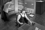Man and woman working with IBM type 704 electronic data processing machine.