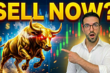 Man in white shirt pointing at a charging golden bull with glowing red eyes, with bold yellow “SELL NOW?” text overlay against a backdrop of green and red stock charts.