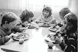 Kids having lunch at an East German school in 1975