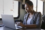 A young woman works on her computer.