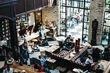 A crowded cafe on a sunny day.