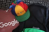 Google swag products, including a cap, t-shirt, and backpack