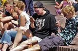 kids using their smartphones around a fountain