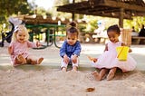 three children in a sandbox